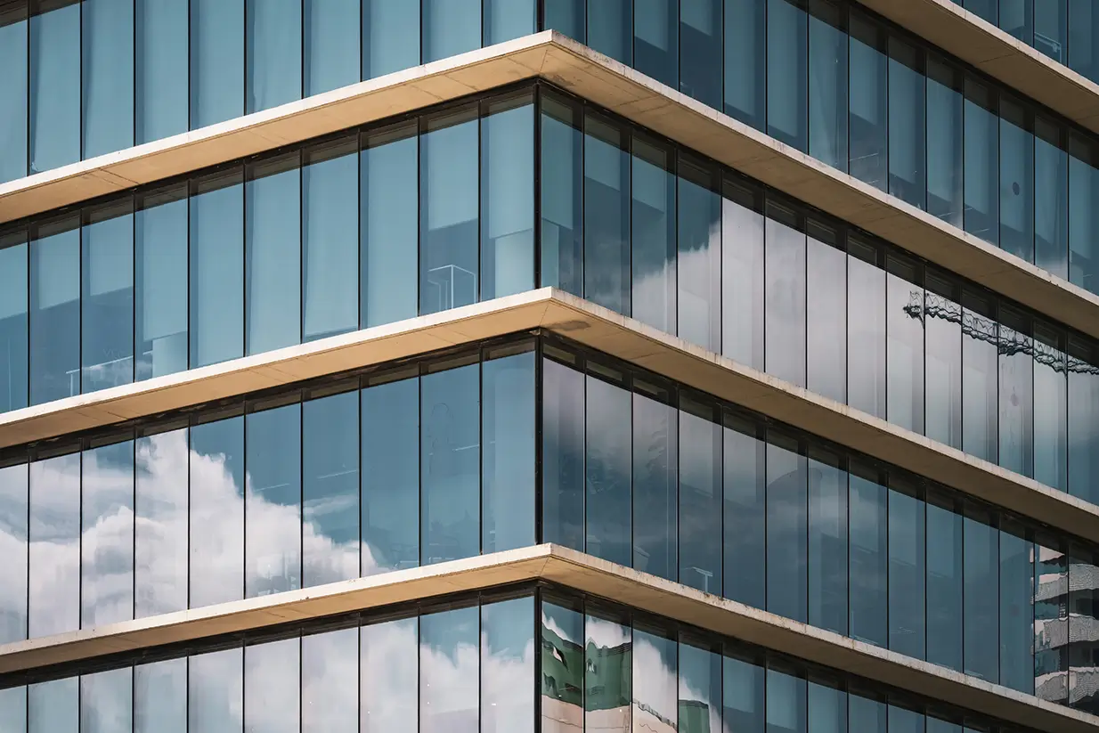 symmetrical-view-corner-office-building-with-vertical-glazed-windows