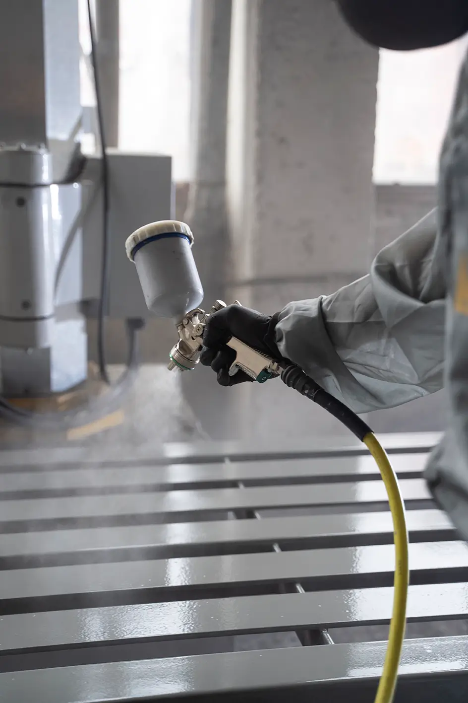 worker-spraying-powder-paint-side-view copy